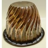 A large Victorian circular copper jelly mould for a banquet, swirl fluted. 9in (23cm).