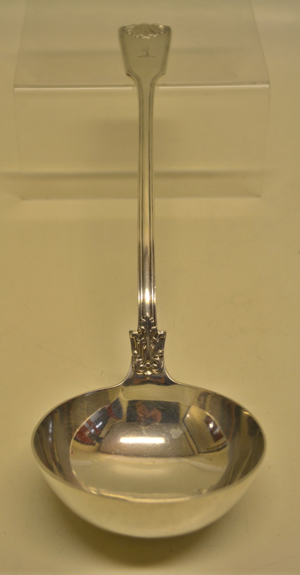 A Victorian Queens husk pattern soup ladle, engraved a crest, having a circular bowl. Maker George