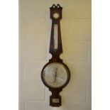 A William IV mahogany banjo shape wheel barometer, the swan neck pediment with silvered atmosphere