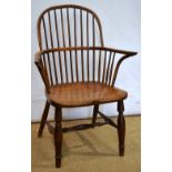 An early nineteenth century yew Windsor armchair the hooped stick back to an elm seat the front