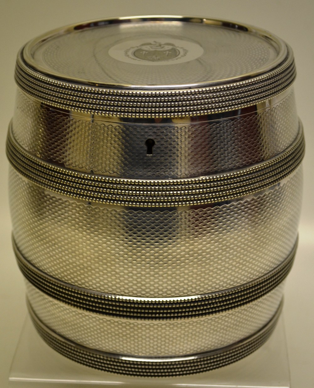 A Victorian electroplated biscuit barrel, engine turned with beaded coopering, the hinged lid