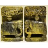 A pair of Chinese green hardstone carved bookends, depicting elephants with blankets engraved