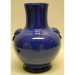 A Chinese deep blue porcelain vase, the body with raised lion masks to the shoulders, having a
