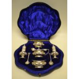 A silver double condiment set, with partly panelled bodies, the pair of baluster peppers with