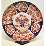 A Japanese late nineteenth century Imari porcelain large charger, decorated an urn of flowers and