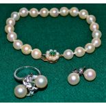 A cultured pearl bracelet on 9 carat emerald and cultured pearl set snap, together with a cultured