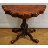 A Victorian walnut card table, the baize lined shaped fold over flap top veneered in burr figured