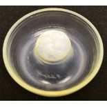R. Lalique a milky glass ash tray with raised prunt of 'SIRENES', signed. 4.5in (11.5cm) diameter.