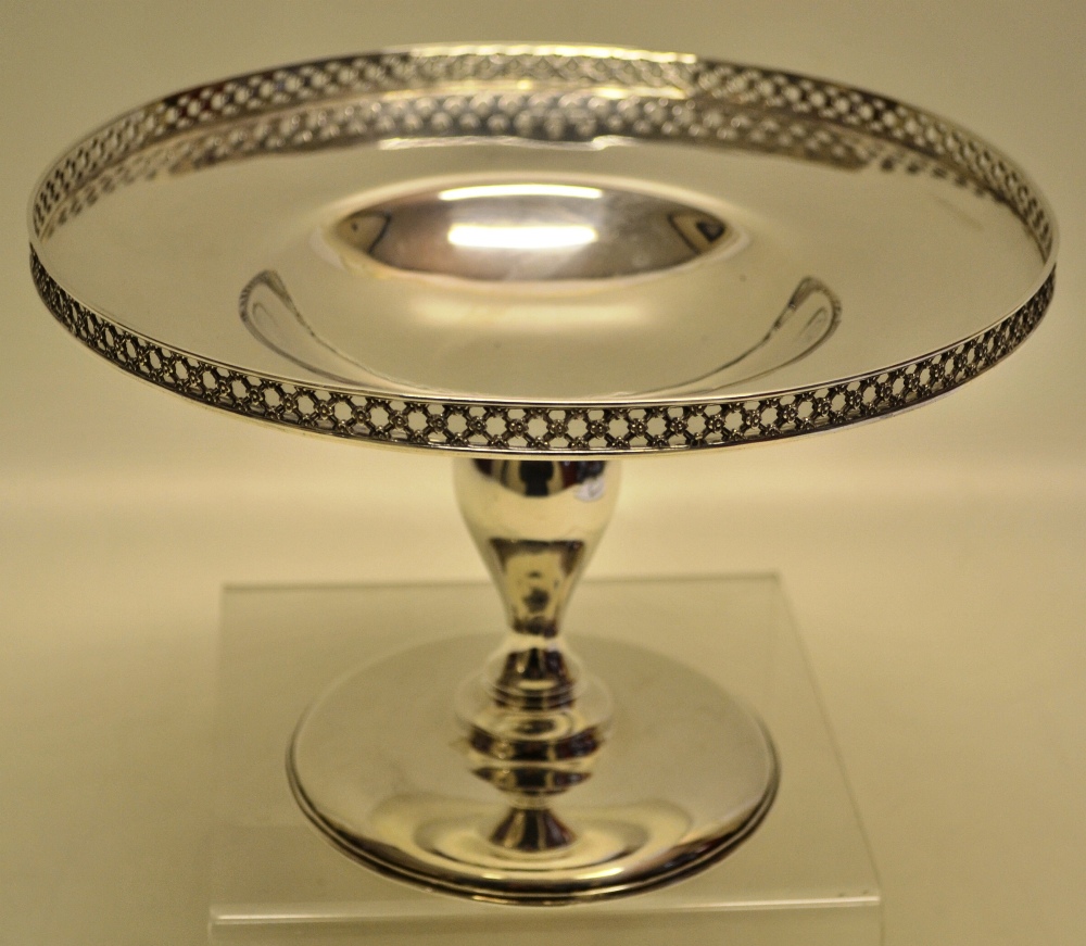 A George V silver circular tazza, the welled dish with a raised pierced trellis border, on an