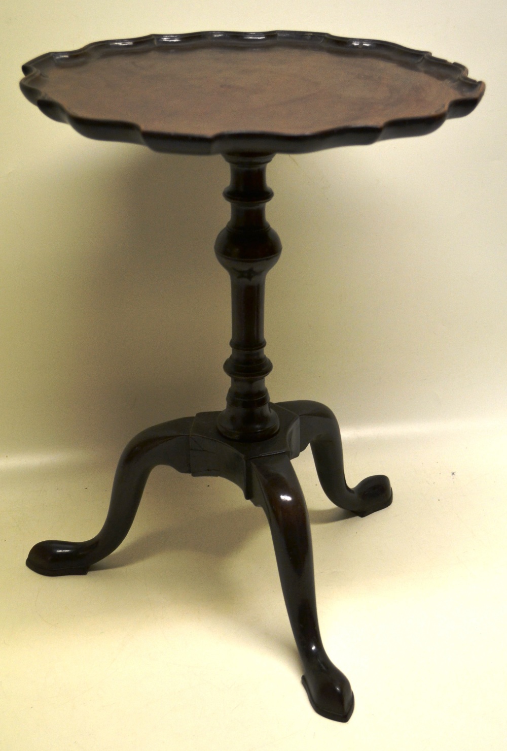 A mahogany occasional table, the circular top with a raised Bath edge border, the baluster turned