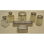 A Victorian cut glass set of toilet boxes and bottles with silver lids, engraved initials, foliage