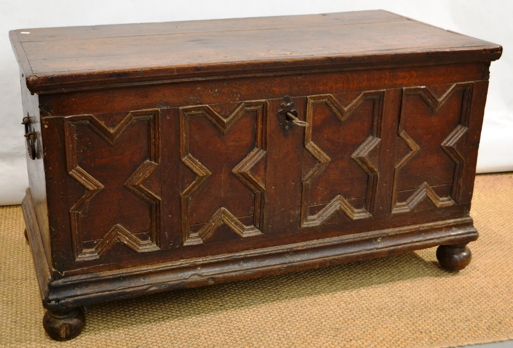 A seventeenth century Flemish oak coffer, with a geometric panelled front, original iron work and