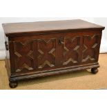 A seventeenth century Flemish oak coffer, with a geometric panelled front, original iron work and