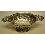 A Dutch antique silver brandy bowl, the oblong bowl with repouse cherubs heads and foliage above