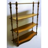 A set of Victorian maple wall shelves serpentine fronted and on turned supports. 26.5oz (67cm).