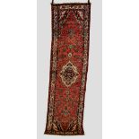 Two Hamadan runners, north west Persia circa 1930s-1940s, the first: 9ft. 10in. x 2ft. 9in. 3m. x
