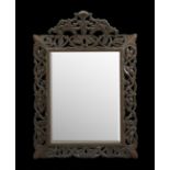 Continental Carved Walnut Mirror, fourth quarter 19th century, the "rustic" pattern inner frame