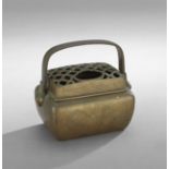 Chinese Bronze Hand Warmer, 19th century, with a floral rondel motif on the sides and a pierced lid,