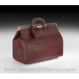 Les Must de Cartier Bordeaux Leather Bag, probably 20th century, French, with a snap closure on