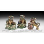 Three Chinese Pottery Foo Dogs, 20th century, including a male and female pair on lotus bases and