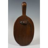 An oak bread board carved with a mouse,