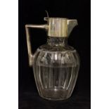 A cut glass claret jug with silver colla