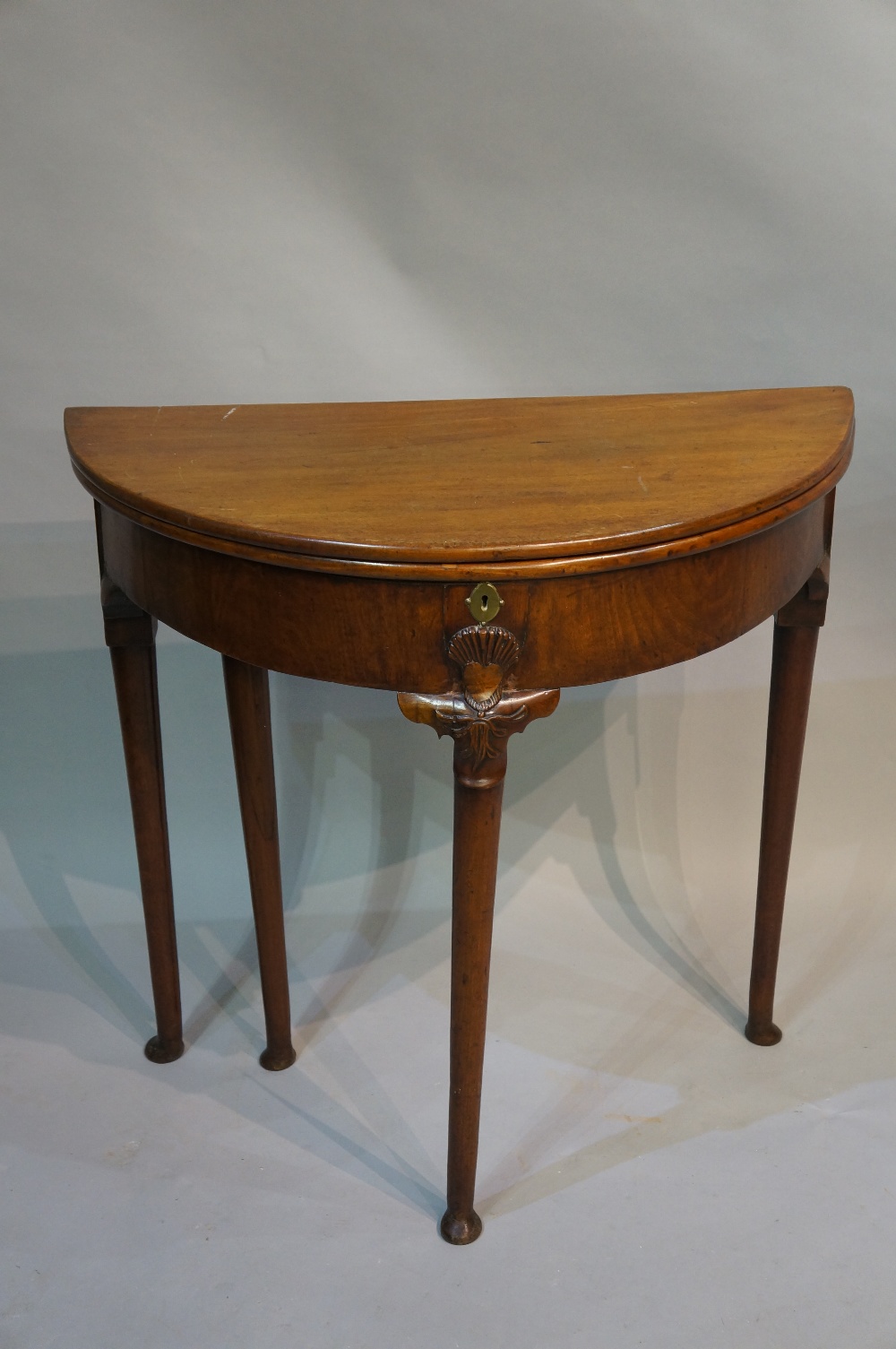 A George II mahogany D-shaped tea table