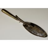 A George III scissor style fish server with pierced oval blades each crested, reeded handle, 30 cm