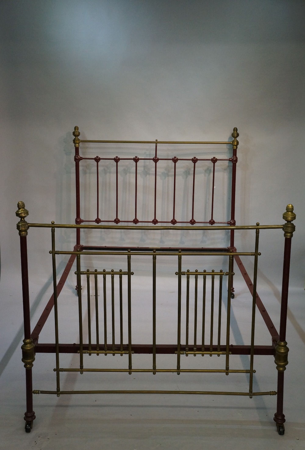 A Victorian cast iron and brass bedstead