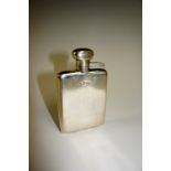 A silver hip flask with hinged cover the