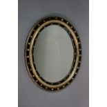 A Victorian oval wall mirror, silvered,