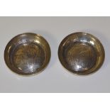 A circular silver dish the domed base en