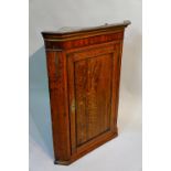 A George III oak hanging corner cupboard