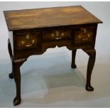 An early George III oak lowboy outlined