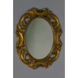 A giltwood wall  mirror the oval plate w