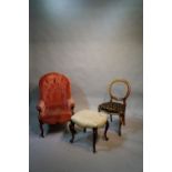 A Victorian armchair; a Victorian uphols