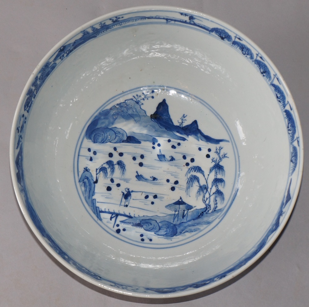 A Chinese blue and white bowl decorated to the exterior with travelling figures in landscapes, - Image 2 of 3