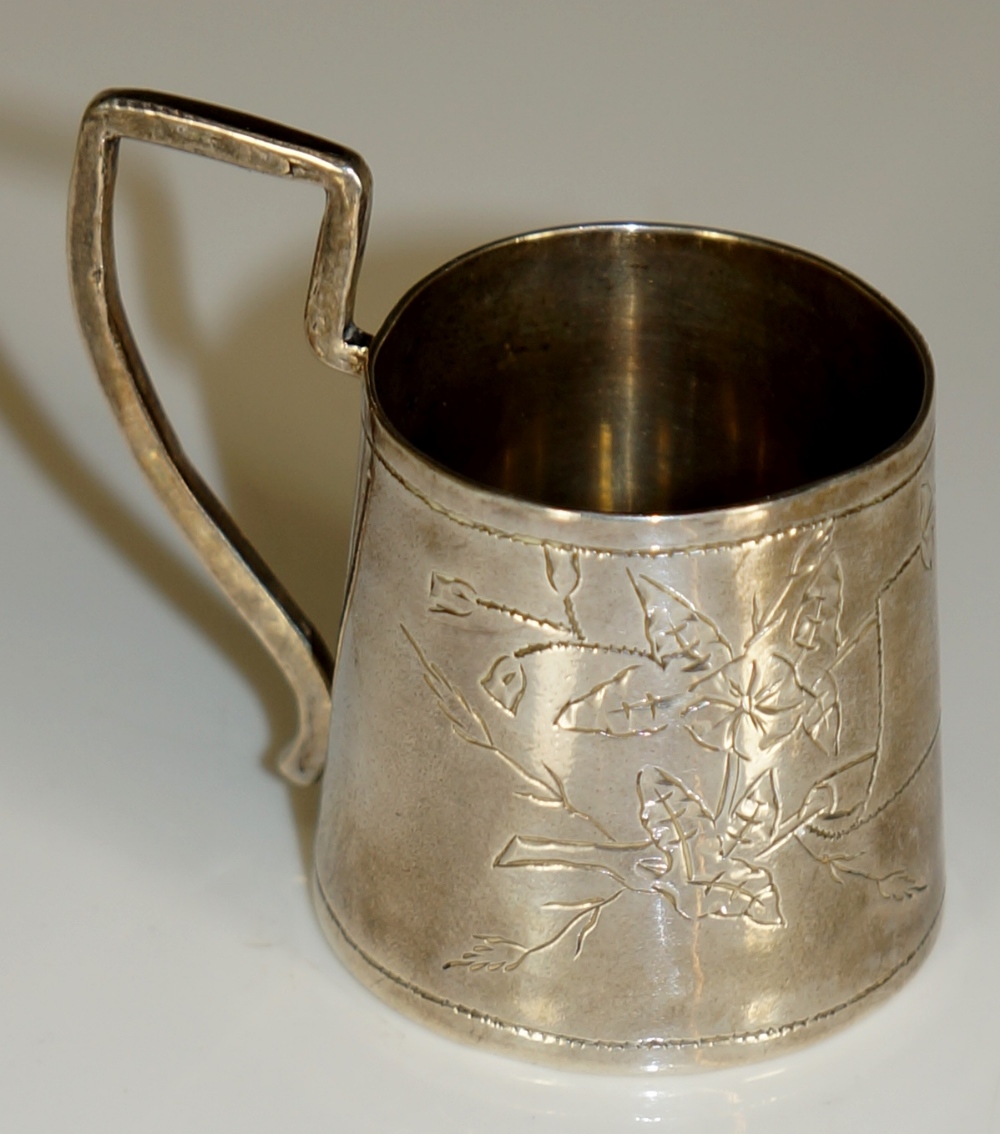 A Russian miniature tapered cylindrical beaker with angular handle the body engraved with