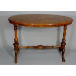 A Victorian oval walnut centre table the figured quarter veneered top above fluted vasular legs