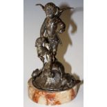 A silvered spelter figural group of a winged amorini and hound on a shell and game bird base,