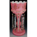 A pink glass lustre, with enamelled foliate and beaded design,