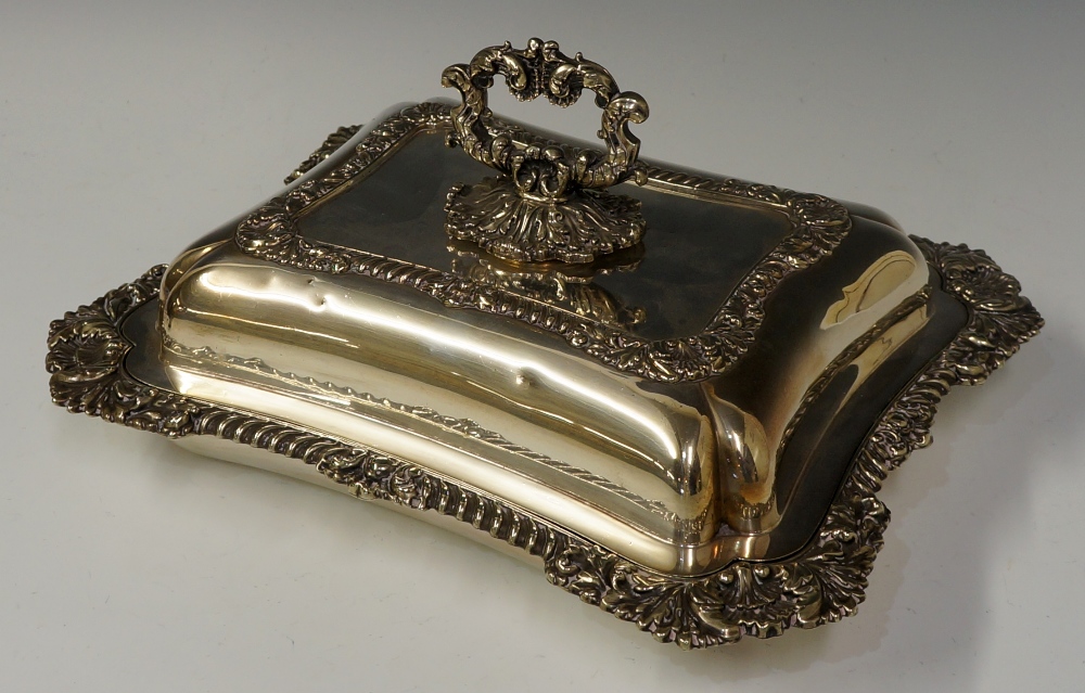 A shaped rectangular entrée dish in George III style the rims cast with shells and leafage,