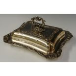 A shaped rectangular entrée dish in George III style the rims cast with shells and leafage,