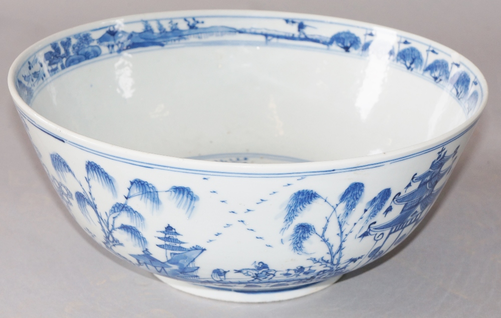 A Chinese blue and white bowl decorated to the exterior with travelling figures in landscapes,