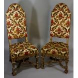 A pair of late 17th Century style upholstered chairs the arched backs and stuffed over seats