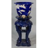 A Mintons pottery jardiniere in Japanese revival style the blue body decorated in relief in white