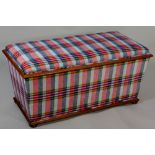 A Victorian mahogany framed ottoman of conventional design upholstered in modern Tartan fabric on