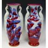 A pair of Jun ware porcelain vases modelled with stylised peacock handles,