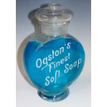 An early 20th Century glass container enamelled in white 'Ogston's Finest Soft Soap', 25cm high,