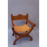 Robert Thompson Of Kilburn - an English oak X-frame chair the back with horizontal rail carved with